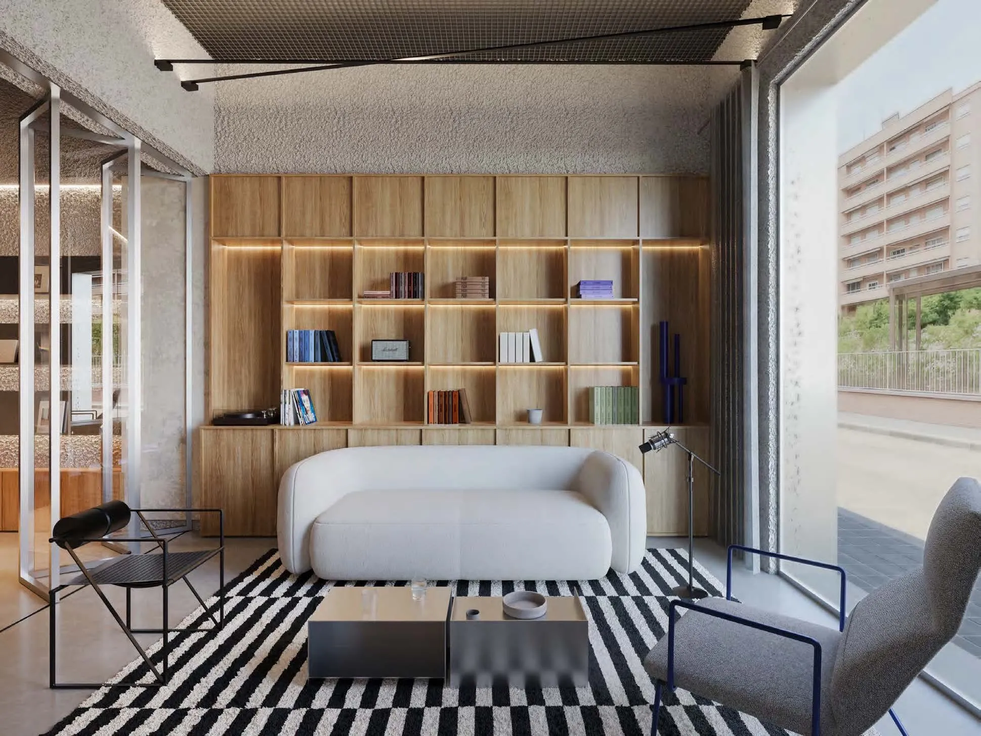 Visualización de la zona lounge con estanterías de libros y vinilos